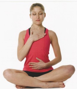 Woman meditating in seated yoga pose.
