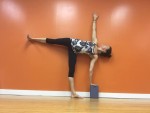 Person doing a yoga pose against an orange wall. Person doing a yoga pose against an orange wall.
