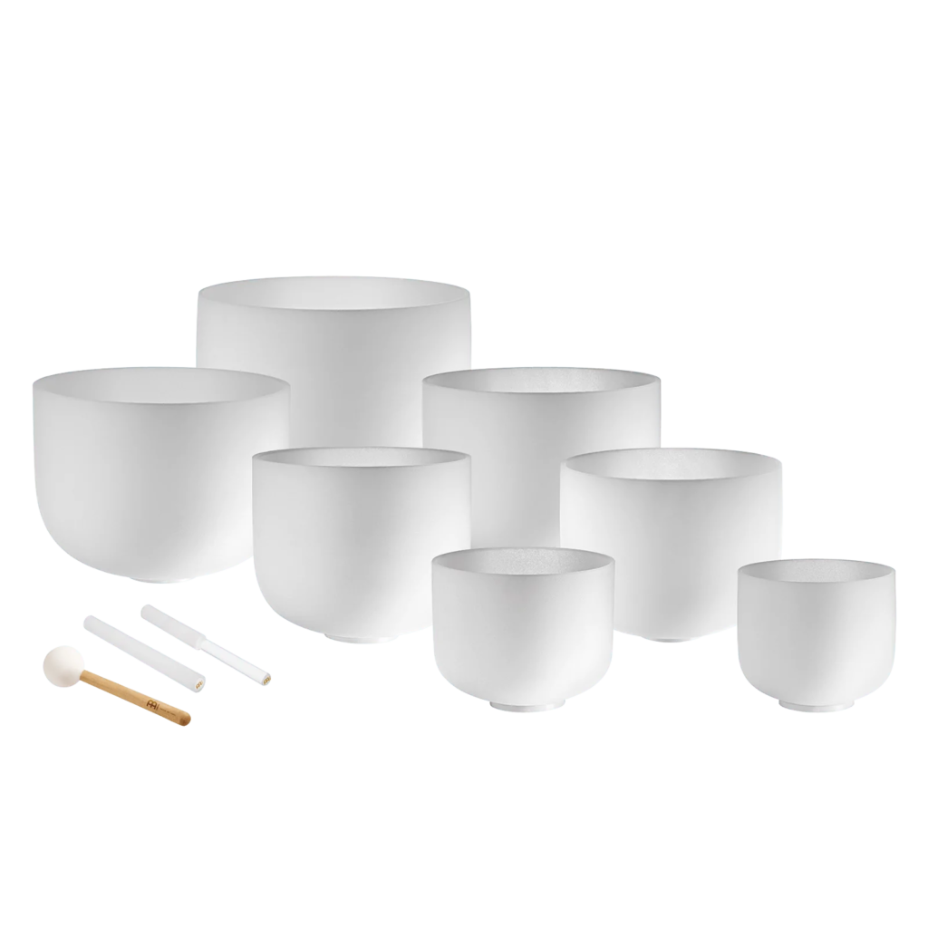 Set of white quartz crystal singing bowls with mallets.